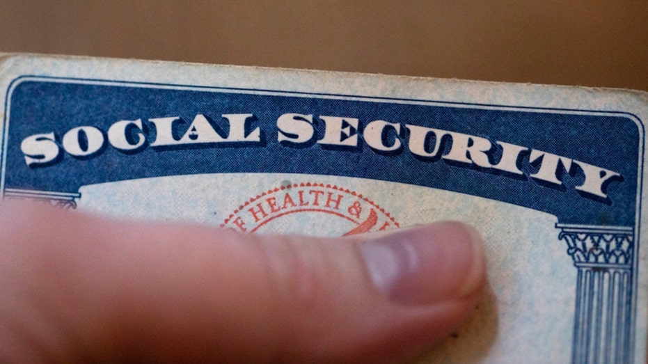 A person holds a Social Security card