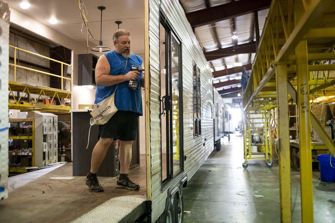 A worker installs interior wiring on a destination recreational vehicle at the HL Enterprise manufacturing facility in Elkhart, Indiana, on October 8, 2020.